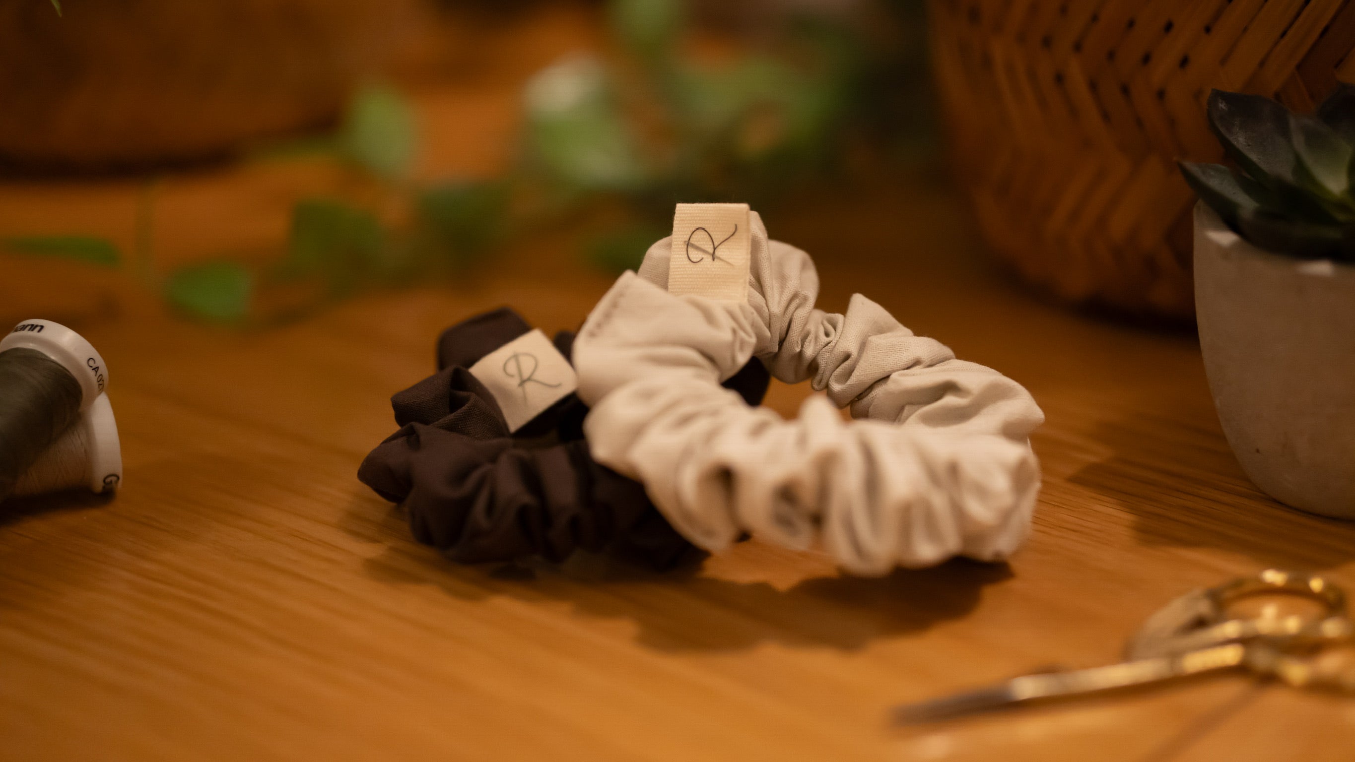 Two small scrunchies on a wooden surface
