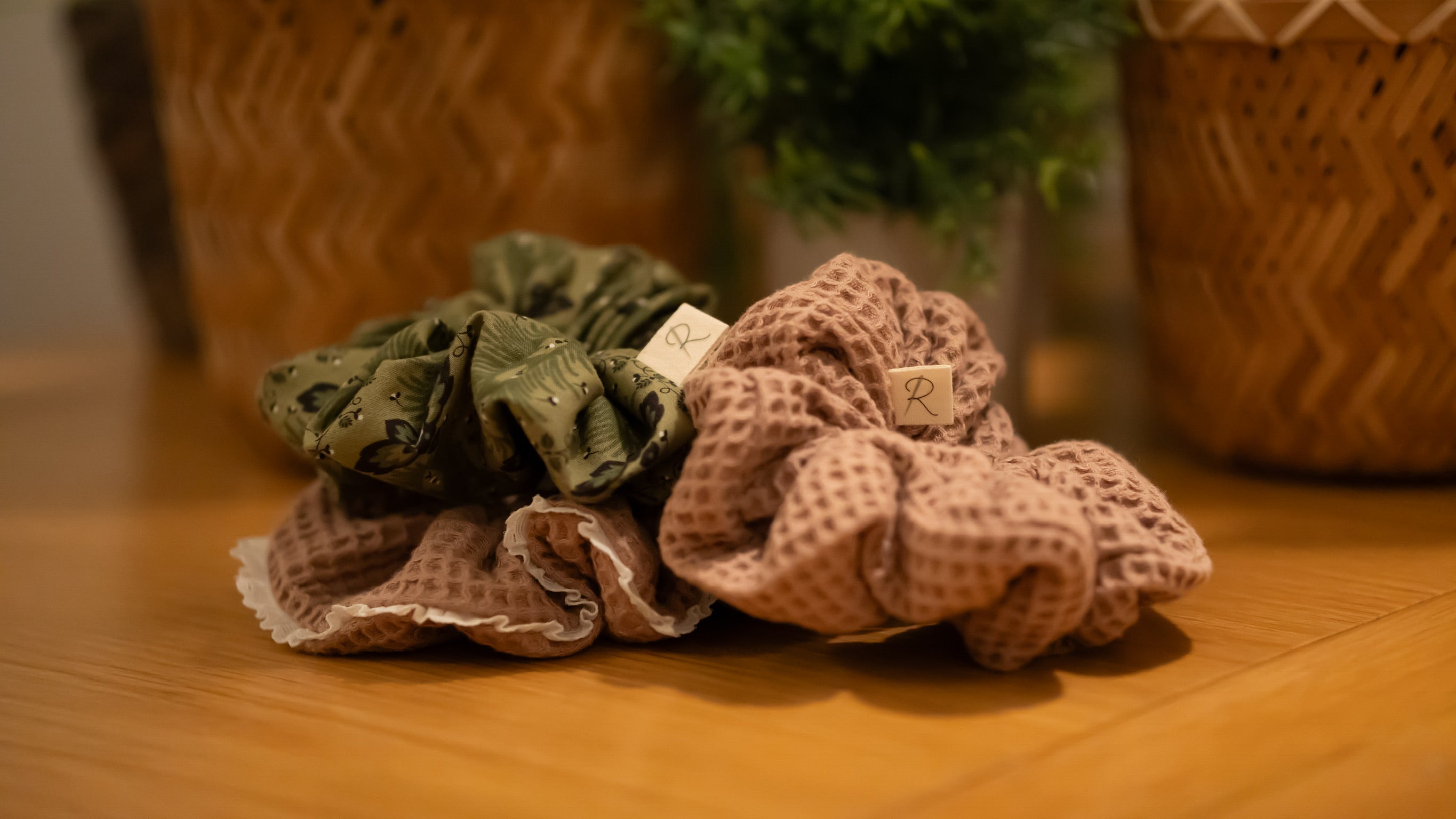 A selection of fabric scrunchies on a wooden surface