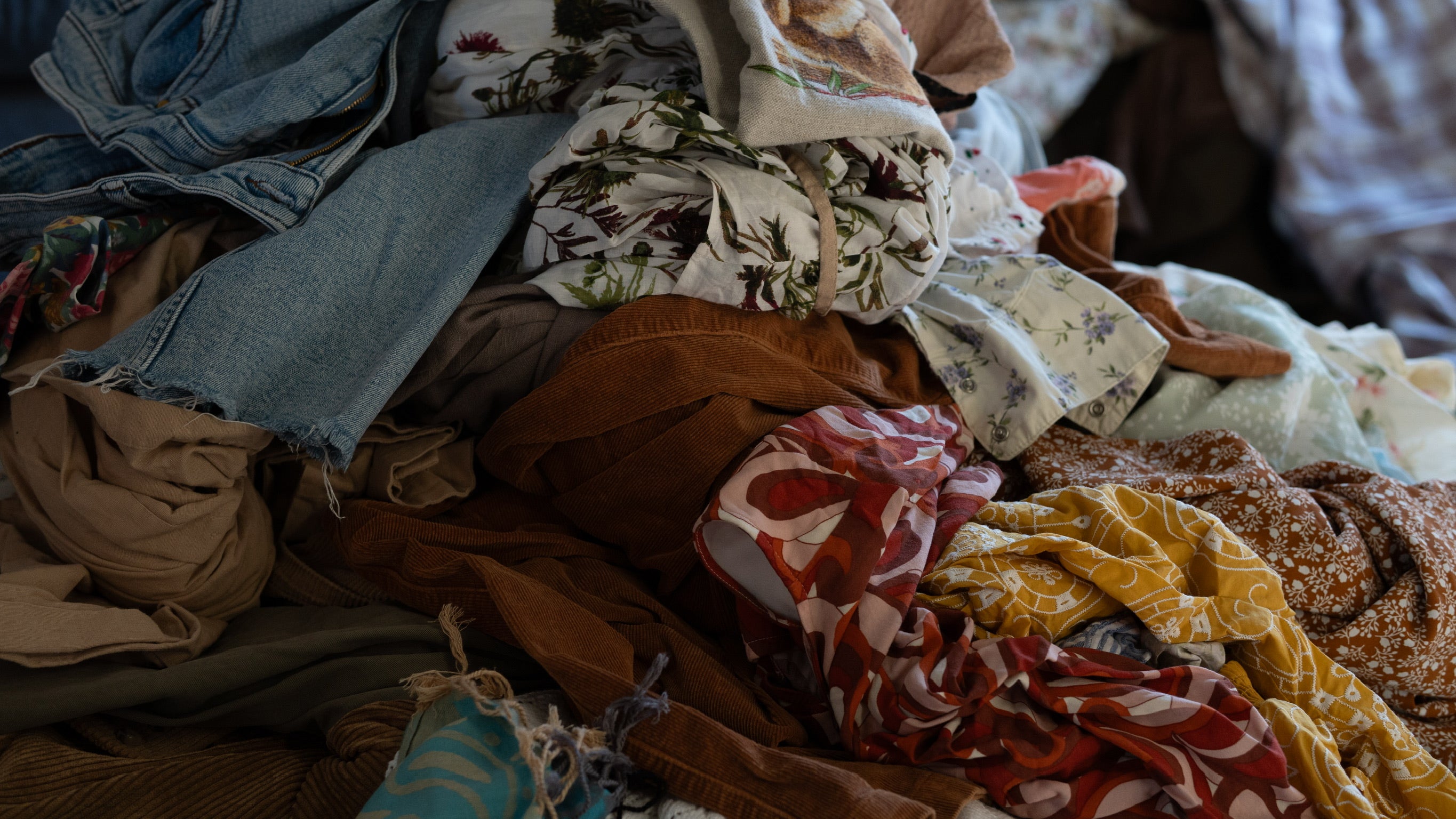 Stack of various fabrics in different colors and patterns