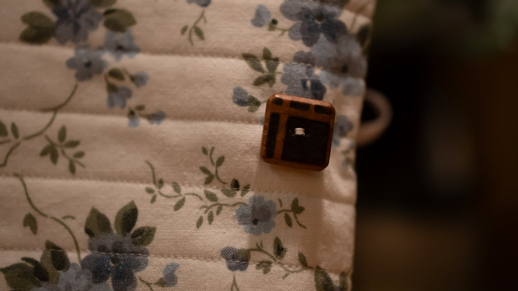 Close up of brown button on floral background