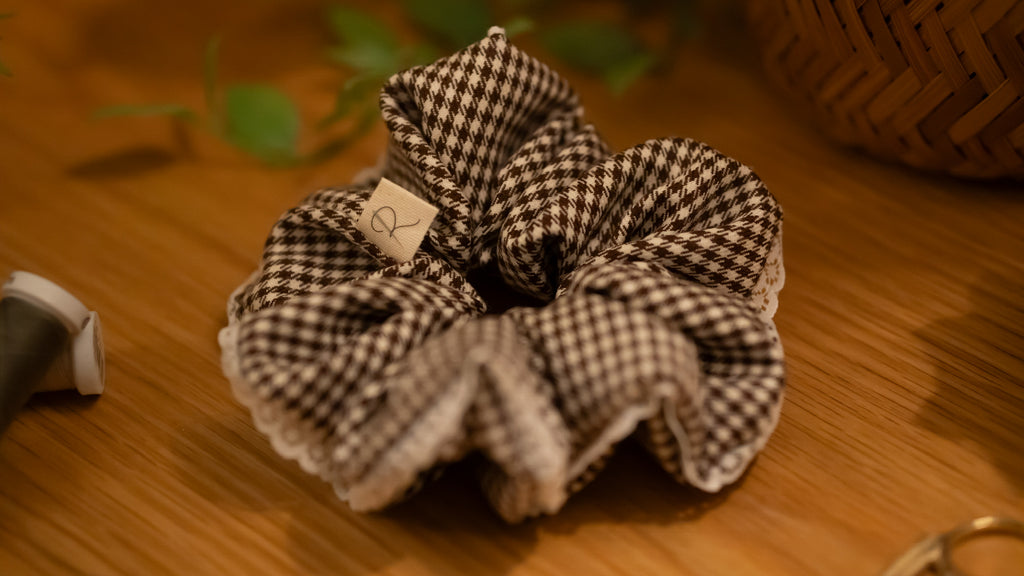 Gingham checkered scrunchie on a wooden surface