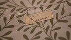 Fabric with a leaf pattern and a 'Resewn' label.
