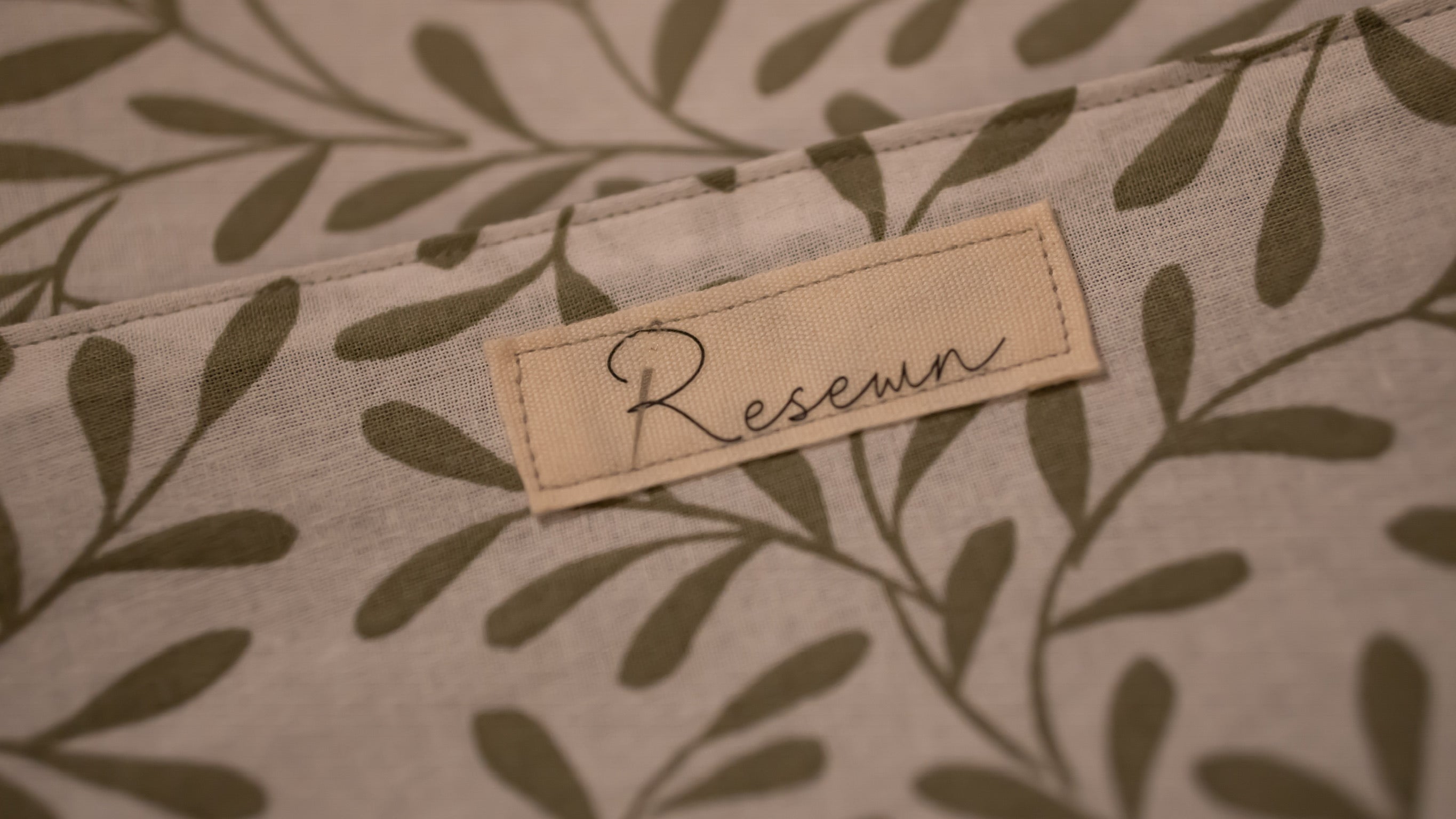 Fabric with a leaf pattern and a 'Resewn' label.