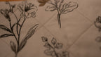 Floral line drawings on a quilted fabric